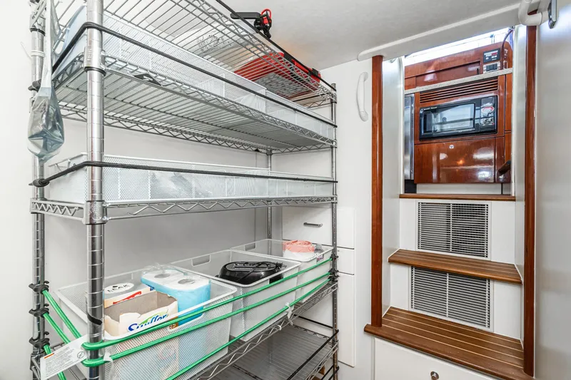 Slide: The Image of Storage area in 2002 Fairline Squadron 58 yacht with metal shelves and wooden steps. - 47