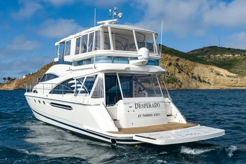 Slide: The Image of Luxury 2002 Fairline Squadron 58 yacht cruising near scenic coastline. - 5