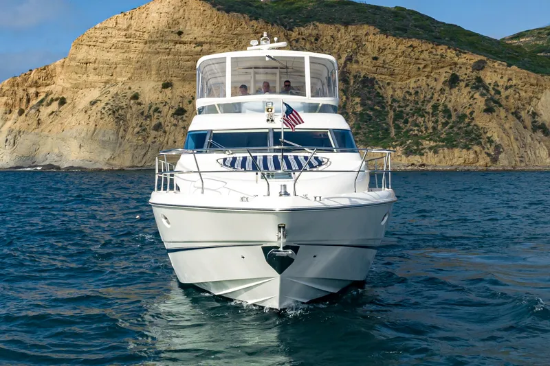 Slide: The Image of 2002 Fairline Squadron 58 yacht cruising near rocky coastline. - 8