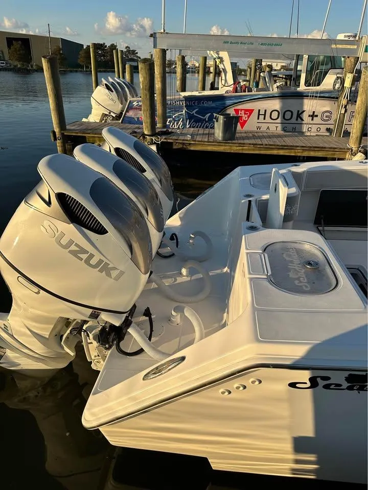 Slide: The Image of 2024 SeaHunter 39 Tournament boat with Suzuki engines docked at marina. - 2