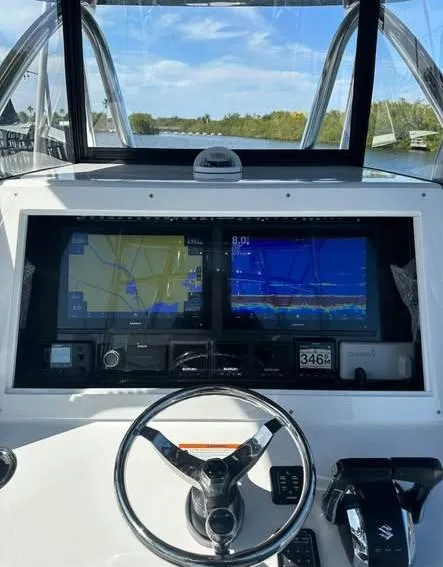 Slide: The Image of 2024 SeaHunter 39 Tournament boat dashboard with navigation screens and steering wheel. - 3