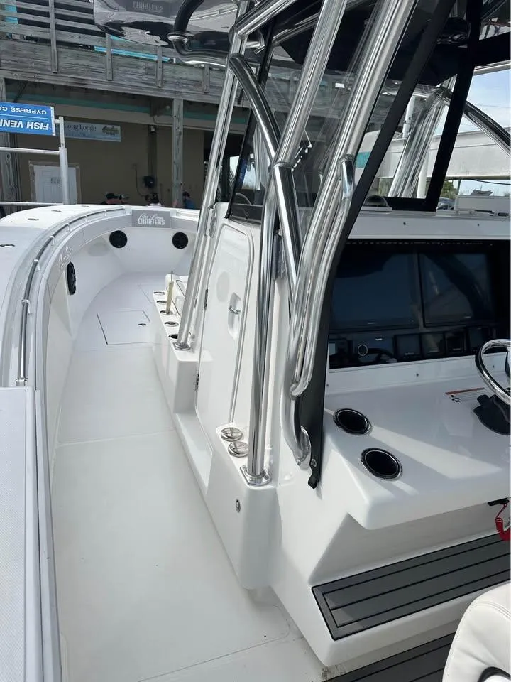 Slide: The Image of 2024 SeaHunter 39 Tournament boat, sleek design, advanced controls, stainless steel features. - 4