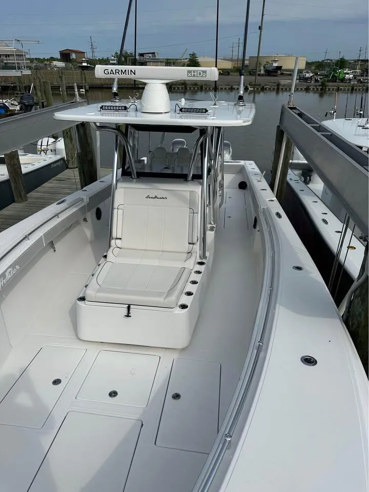 Slide: The Image of 2024 SeaHunter 39 Tournament boat docked, featuring spacious deck and advanced Garmin navigation system. - 8