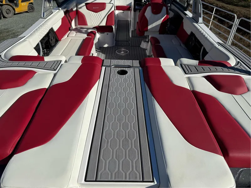 Slide: The Image of 2022 MasterCraft XT24 boat interior with red and white seating, modern design. - 10