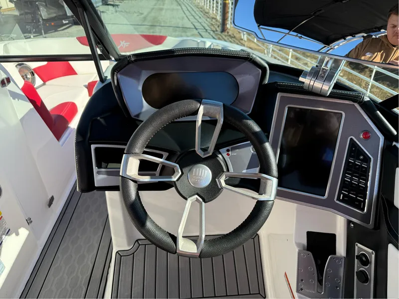 Slide: The Image of 2022 MasterCraft XT24 boat cockpit with steering wheel and control panel. - 11