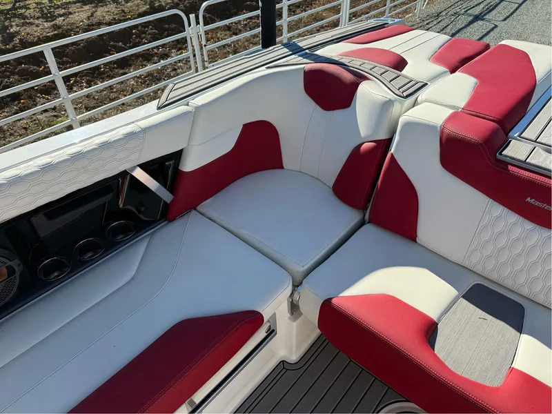 Slide: The Image of 2022 MasterCraft XT24 boat interior with red and white seating, showcasing luxury design. - 14