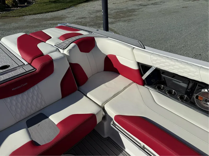 Slide: The Image of 2022 MasterCraft XT24 boat interior with red and white seating, showcasing luxury and comfort. - 16