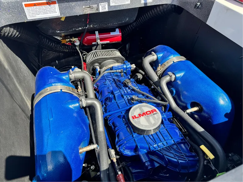 Slide: The Image of 2022 MasterCraft XT24 engine with blue Ilmor components in a boat compartment. - 28