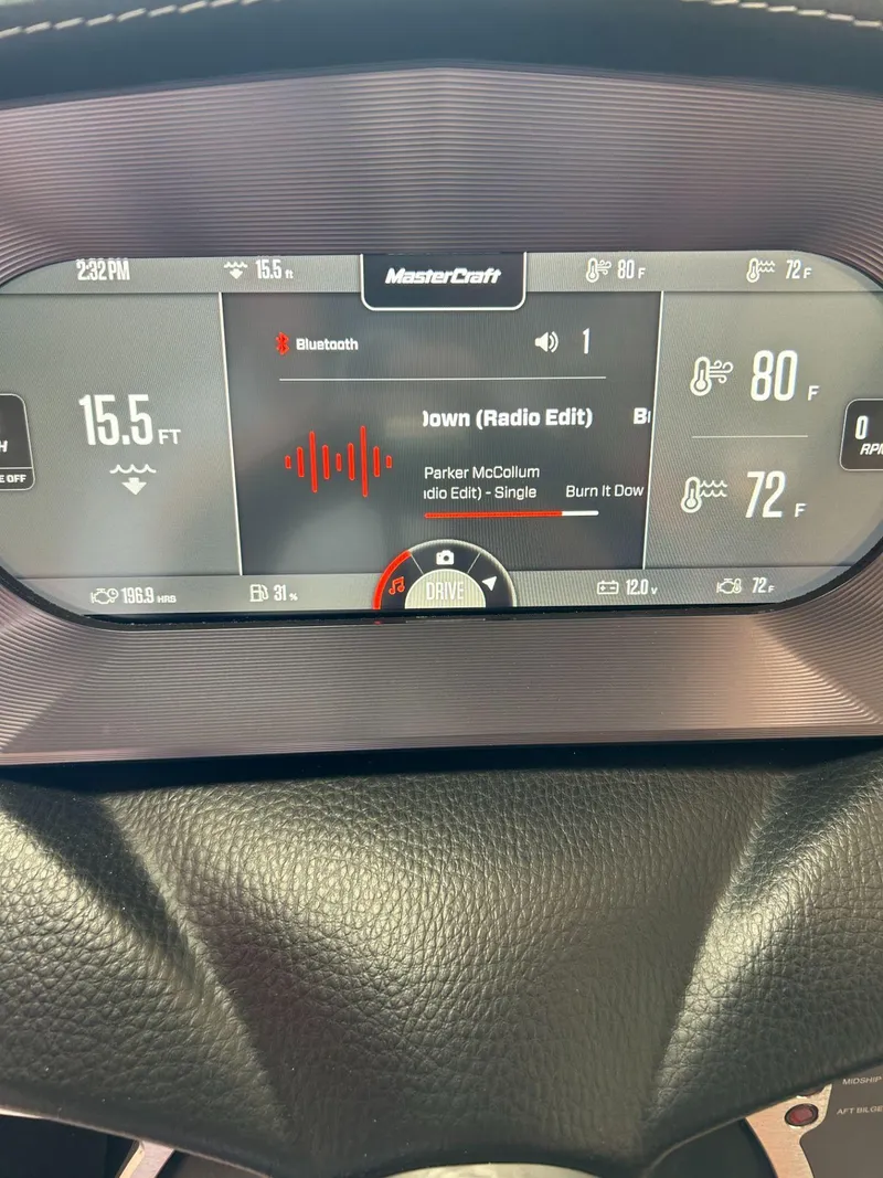 Slide: The Image of 2022 MasterCraft XT24 dashboard displaying music and boat information. - 29