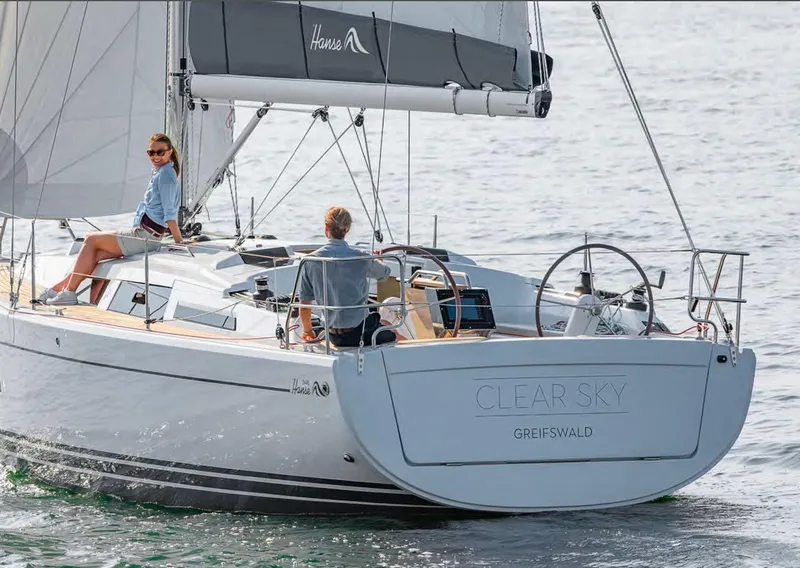 Slide: The Image of 2019 Hanse 348 sailboat named "Clear Sky" sailing on calm waters. - 12