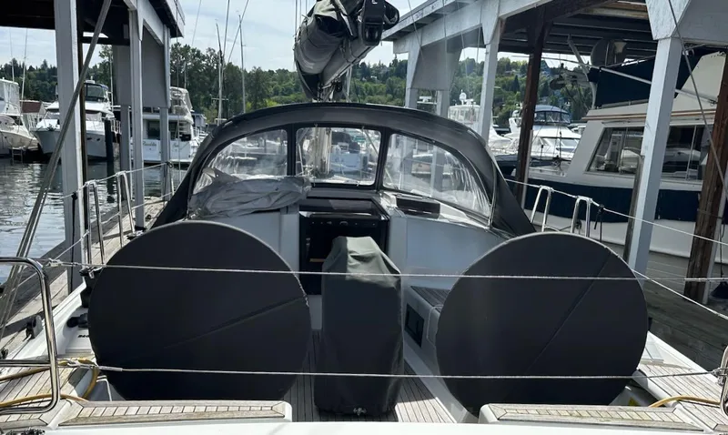 Slide: The Image of 2019 Hanse 348 sailboat docked at marina, featuring covered cockpit and sleek design. - 15