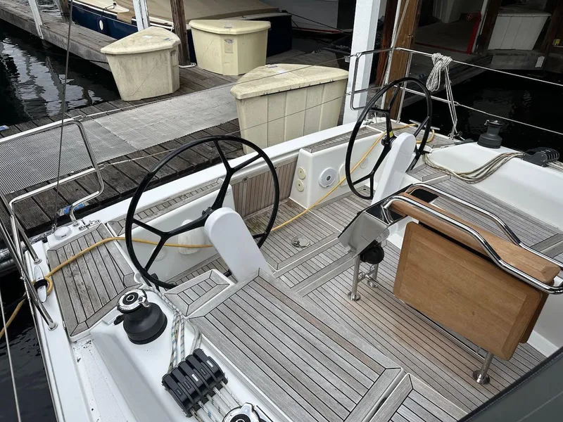 Slide: The Image of 2019 Hanse 348 yacht cockpit with dual steering wheels and teak flooring. - 17
