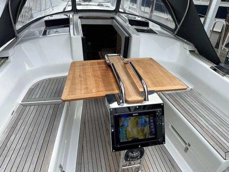 Slide: The Image of 2019 Hanse 348 yacht cockpit with wooden table and navigation display. - 19