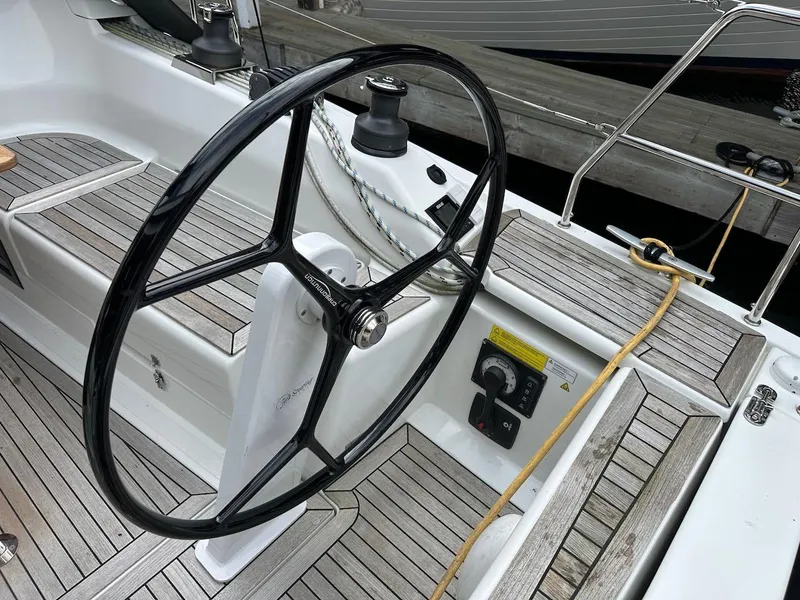 Slide: The Image of Steering wheel of a 2019 Hanse 348 sailboat with wooden deck details. - 21