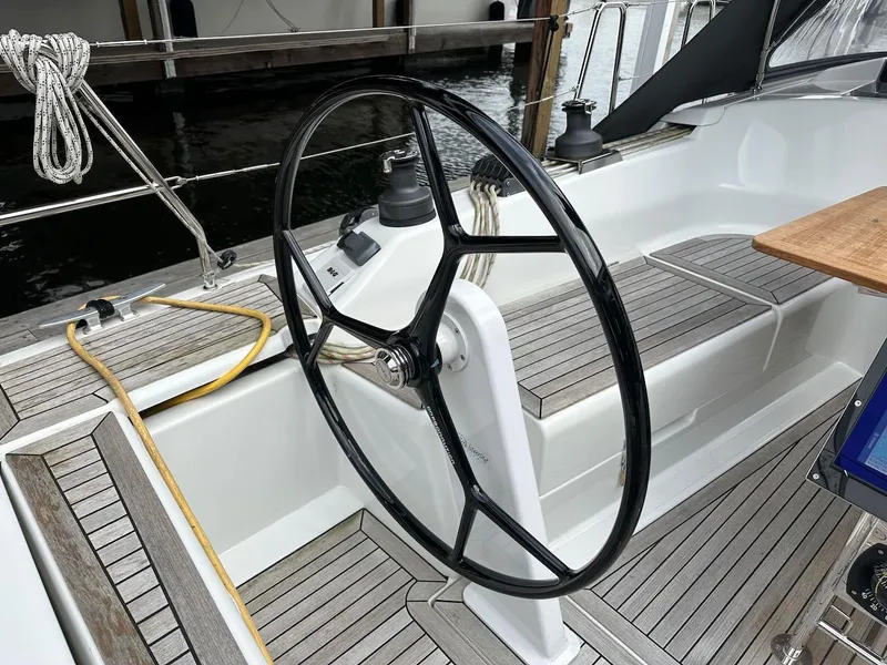 Slide: The Image of Steering wheel of a 2019 Hanse 348 sailboat with teak deck details. - 22