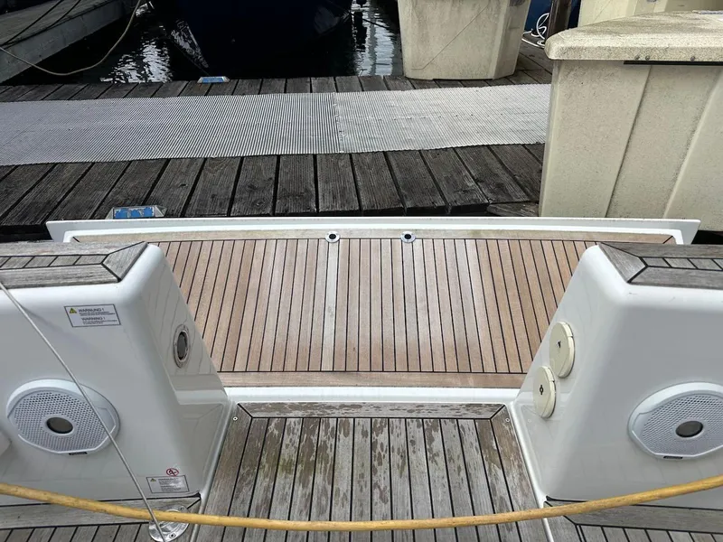 Slide: The Image of Stern view of 2019 Hanse 348 yacht with teak decking at marina. - 23