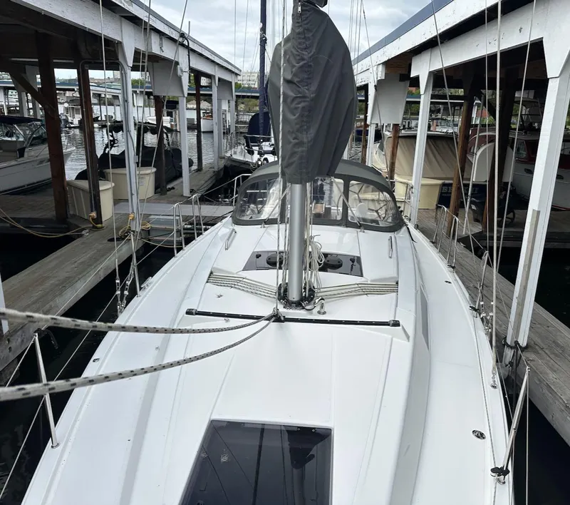 Slide: The Image of 2019 Hanse 348 sailboat docked in a marina, showcasing sleek design and modern features. - 28