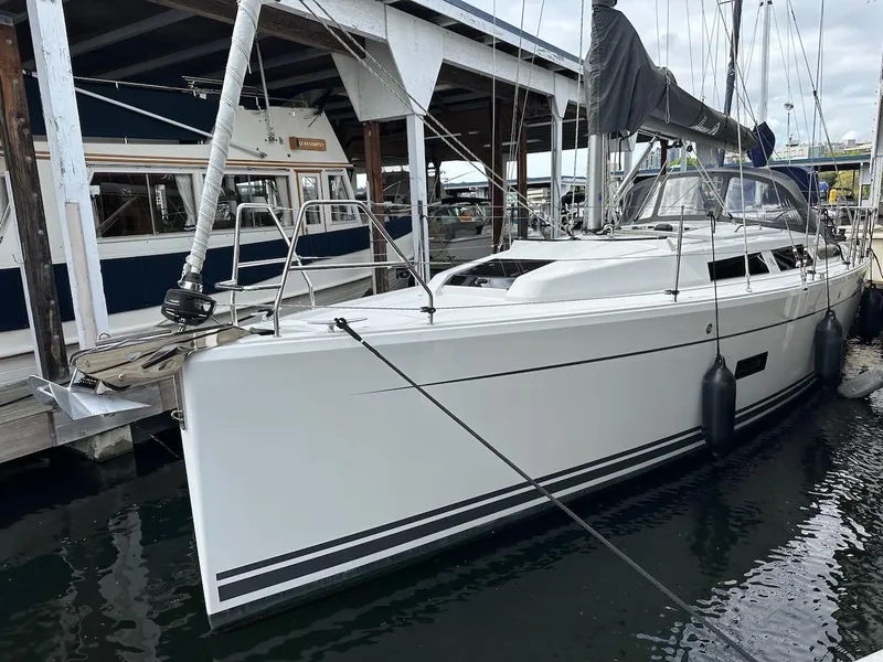 Slide: The Image of 2019 Hanse 348 sailboat docked at marina, featuring sleek white hull and modern design. - 3