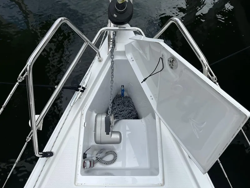 Slide: The Image of 2019 Hanse 348 yacht anchor locker with open hatch and visible chain. - 32
