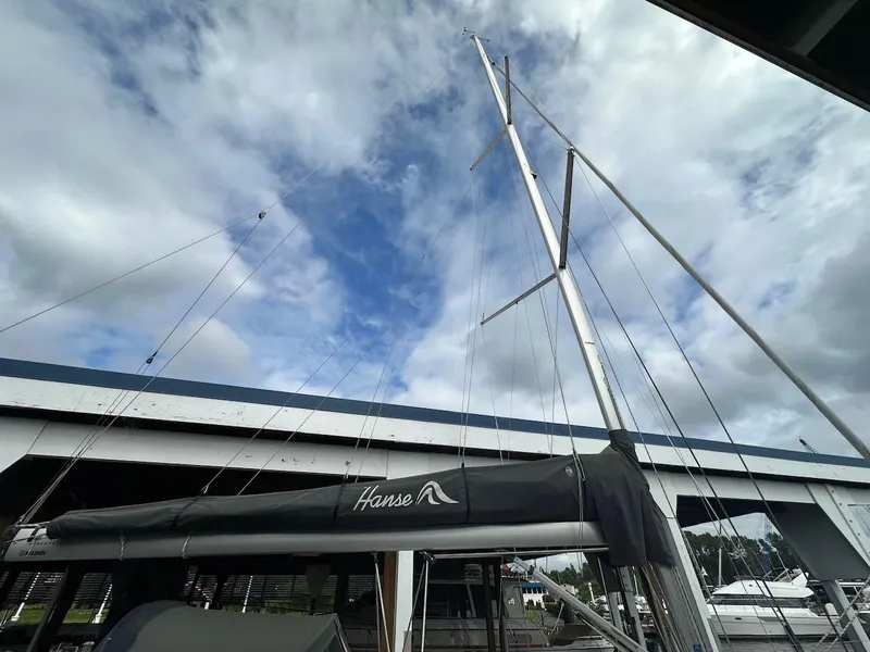 Slide: The Image of Sailboat Hanse 348, 2019 model, docked under cloudy sky near a bridge. - 34