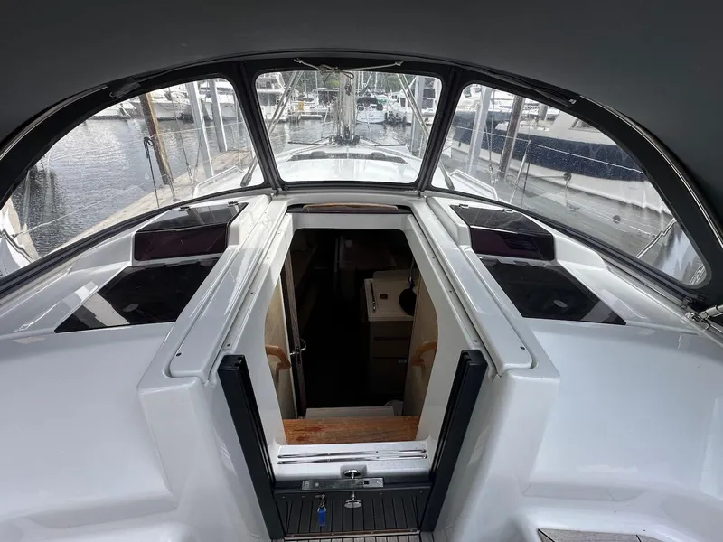 Slide: The Image of 2019 Hanse 348 yacht cockpit with open cabin entrance, docked at marina. - 37