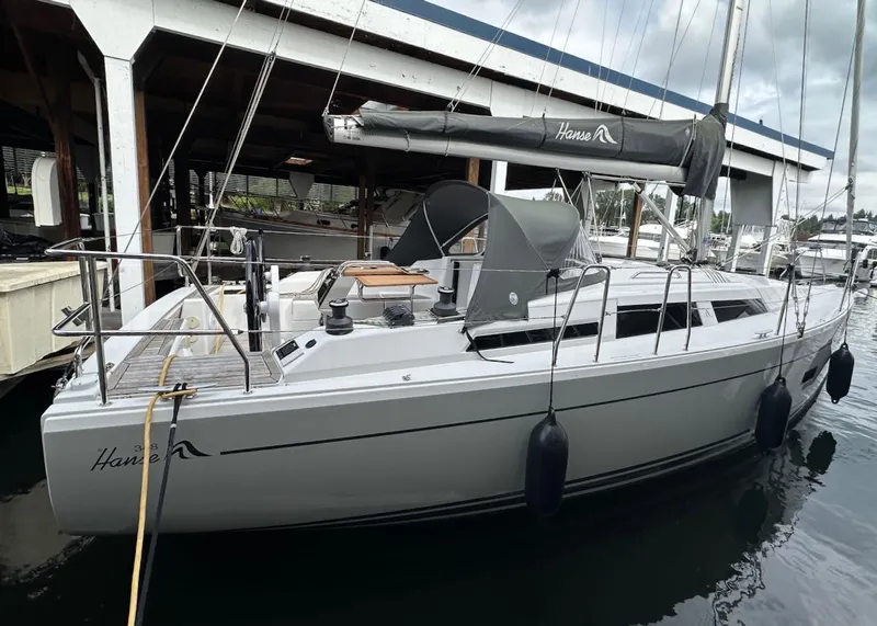 Slide: The Image of 2019 Hanse 348 sailboat docked in marina, featuring sleek design and modern amenities. - 4