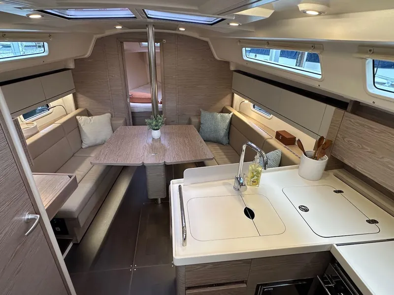Slide: The Image of Interior of 2019 Hanse 348 yacht, featuring modern kitchen and cozy dining area. - 40
