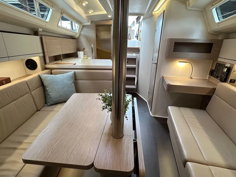 Slide: The Image of 2019 Hanse 348 yacht interior with modern seating, dining table, and ambient lighting. - 42