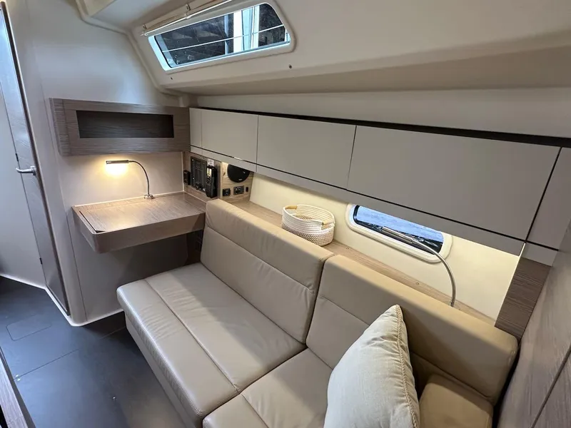 Slide: The Image of 2019 Hanse 348 yacht interior with beige sofa, desk, and modern cabinetry. - 47