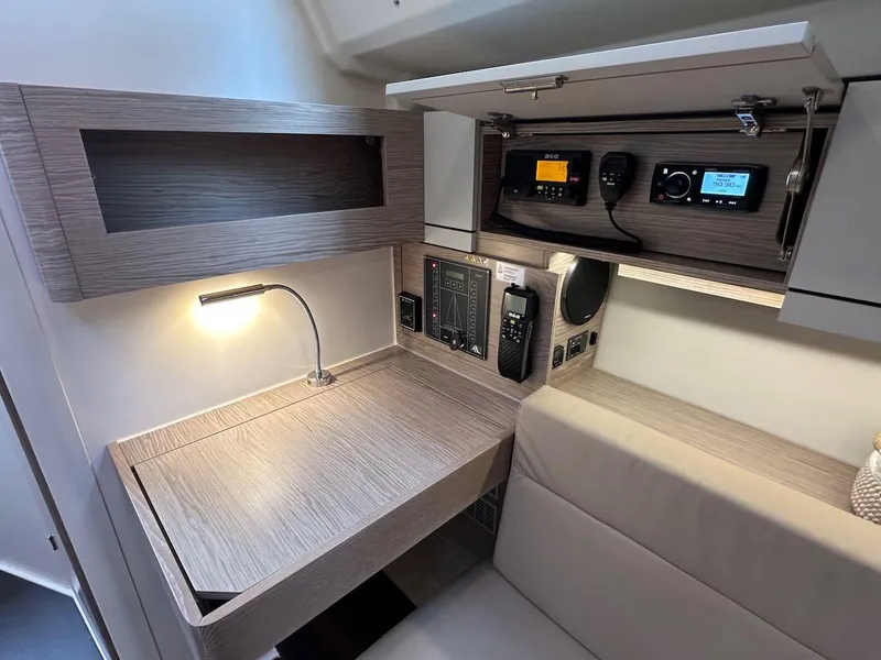 Slide: The Image of 2019 Hanse 348 yacht interior with navigation station and modern control panel. - 48