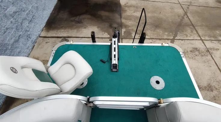 Slide: The Image of 2006 SunChaser 825F boat deck with green carpet and white seating. - 2