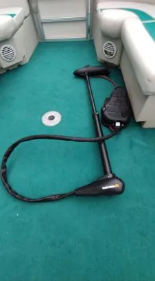 Slide: The Image of 2006 SunChaser 825F boat interior with green carpet and seating. - 4