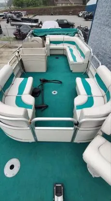 Slide: The Image of 2006 SunChaser 825F pontoon boat with teal and white seating, docked outdoors. - 5