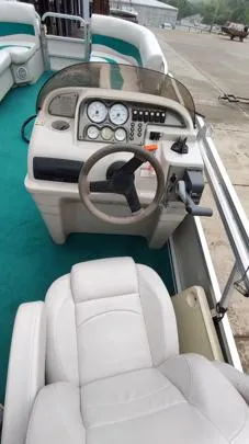 Slide: The Image of 2006 SunChaser 825F boat interior with steering wheel and dashboard controls. - 6