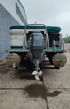 Slide: The Image of 2006 SunChaser 825F pontoon boat with 115 HP outboard motor, parked on concrete. - 8