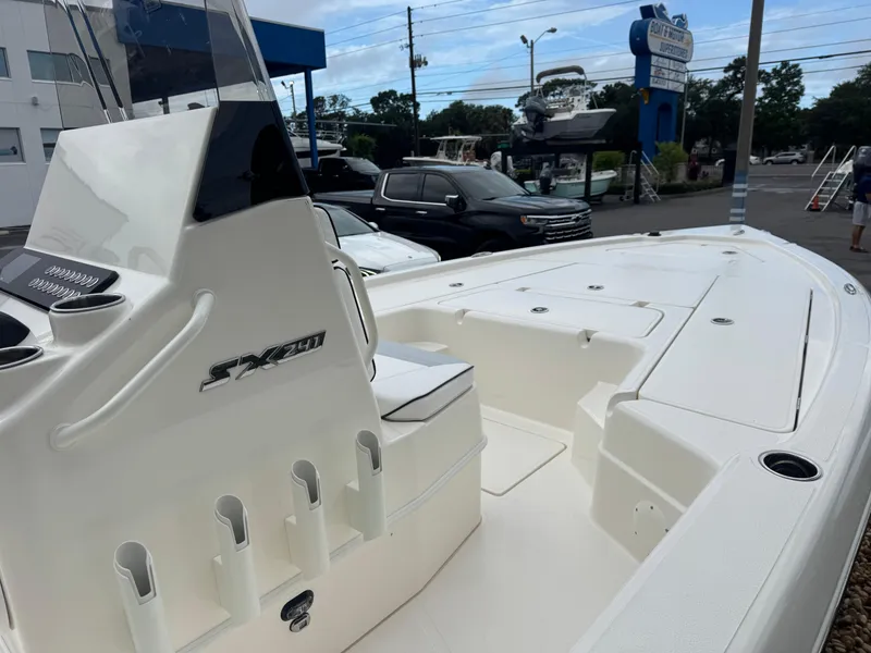 Slide: The Image of 2025 Skeeter SX 241 boat, sleek white design, parked at a dealership. - 11