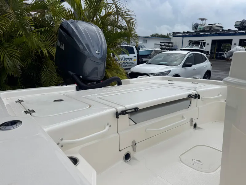 Slide: The Image of 2025 Skeeter SX 241 boat with Yamaha outboard motor, parked near cars and greenery. - 12