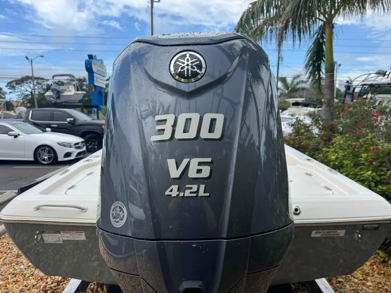 Slide: The Image of 2025 Skeeter SX 241 boat with Yamaha 300 V6 4.2L engine, parked outdoors. - 14
