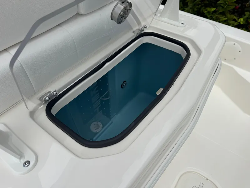 Slide: The Image of 2025 Skeeter SX 241 boat livewell with open lid, showcasing interior design. - 19