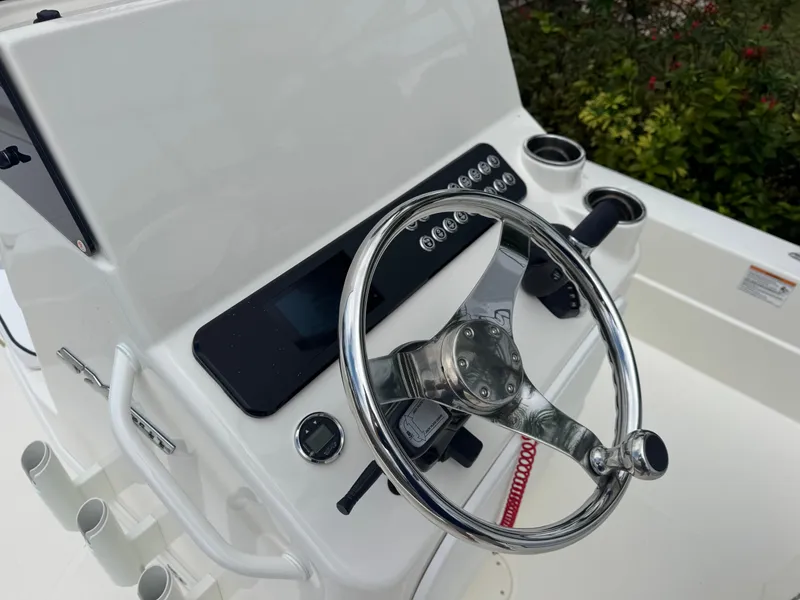 Slide: The Image of 2025 Skeeter SX 241 boat console with steering wheel and control panel. - 22