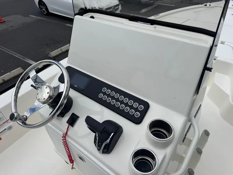 Slide: The Image of 2025 Skeeter SX 241 boat console with steering wheel and controls. - 23