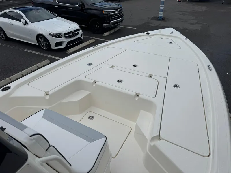 Slide: The Image of 2025 Skeeter SX 241 boat deck in parking lot, showcasing spacious storage compartments. - 24