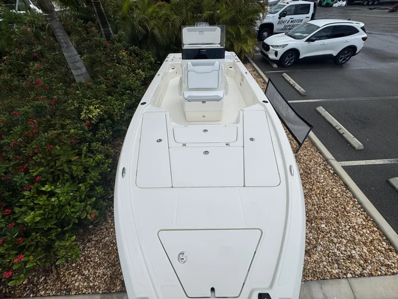 Slide: The Image of 2025 Skeeter SX 241 boat in parking lot, surrounded by greenery and vehicles. - 25