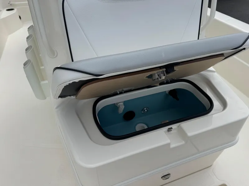 Slide: The Image of Livewell compartment on a 2025 Skeeter SX 241 boat, open and ready for use. - 28