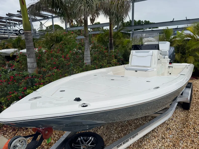 Slide: The Image of 2025 Skeeter SX 241 boat on trailer, surrounded by tropical plants. - 3