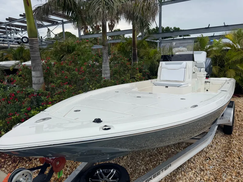 Slide: The Image of 2025 Skeeter SX 241 boat on trailer, surrounded by tropical plants. - 4
