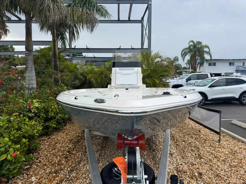 Slide: The Image of 2025 Skeeter SX 241 boat displayed outdoors on a trailer, surrounded by tropical plants. - 5