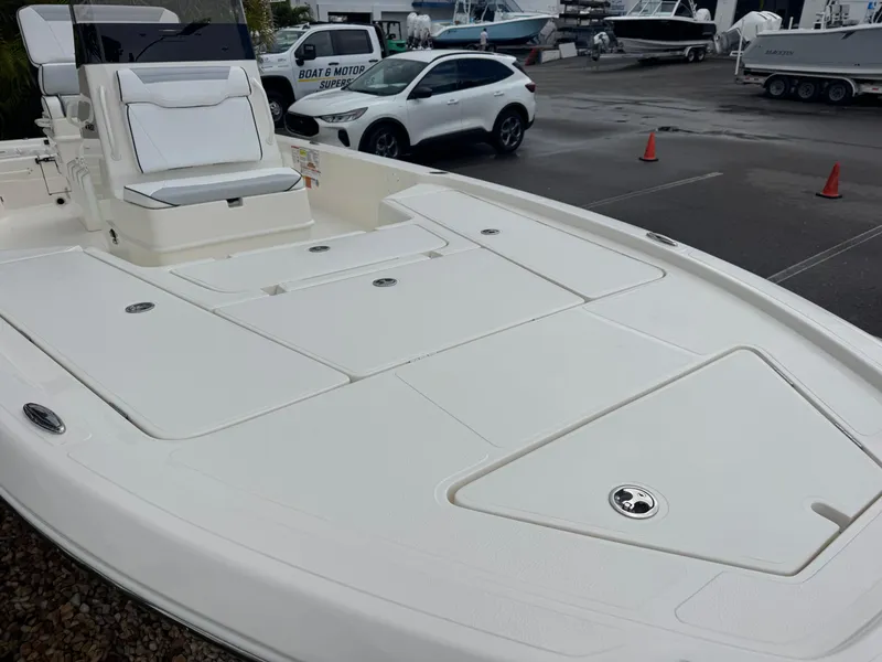 Slide: The Image of 2025 Skeeter SX 241 boat in a marina, showcasing spacious deck and seating. - 7