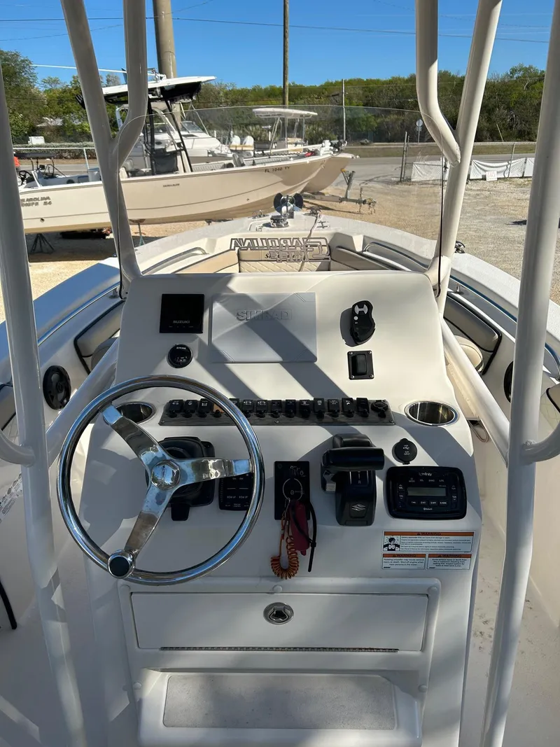 Slide: The Image of 2022 Sea Chaser 22 HFC boat dashboard with steering wheel and controls. - 4