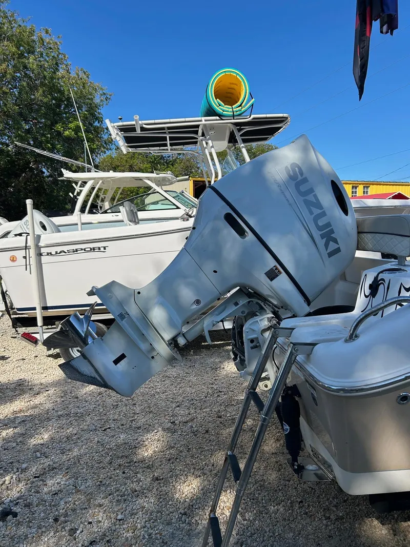 Slide: The Image of 2022 Sea Chaser 22 HFC boat with Suzuki outboard motor, parked on gravel. - 5